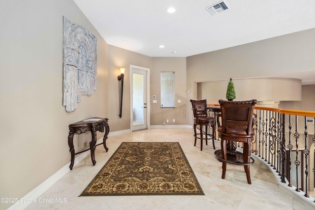 foyer entrance featuring light tile patterned floors, recessed lighting, visible vents, and baseboards