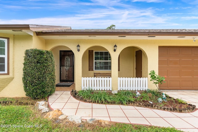 doorway to property with a garage