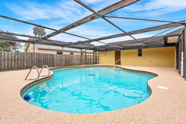 view of swimming pool with a lanai and a patio area