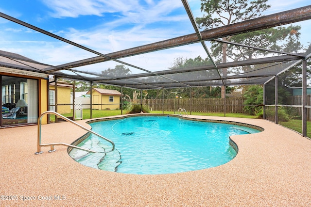 view of swimming pool with a patio area and a shed