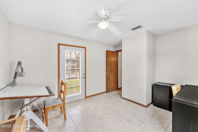 office featuring ceiling fan and a textured ceiling