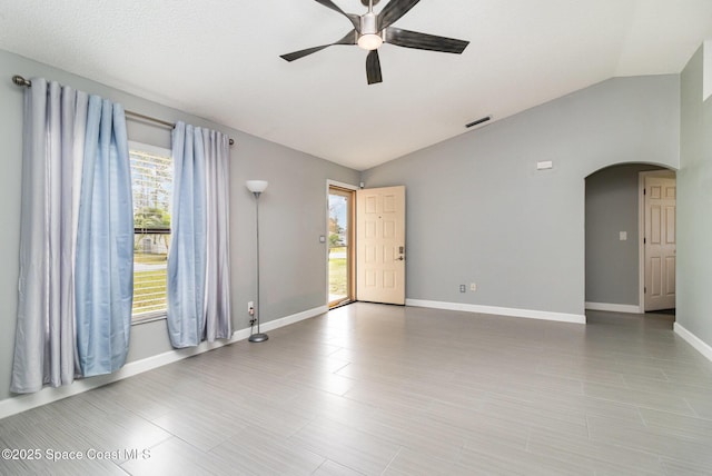 spare room with ceiling fan, plenty of natural light, and vaulted ceiling