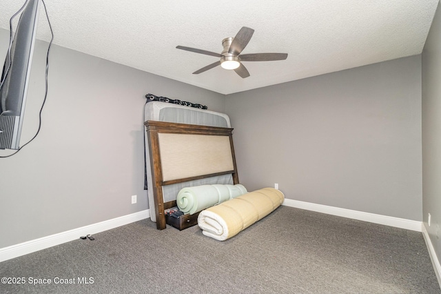 unfurnished bedroom featuring ceiling fan, carpet flooring, and a textured ceiling