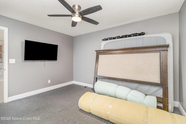 unfurnished bedroom featuring ceiling fan, carpet floors, and a textured ceiling