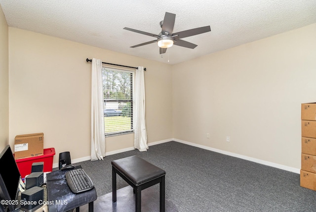 sitting room with ceiling fan, a textured ceiling, and dark colored carpet