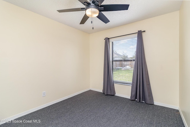 carpeted spare room featuring ceiling fan and a textured ceiling