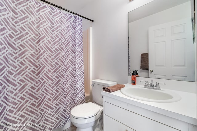 full bathroom featuring vanity, shower / bath combination with curtain, and toilet