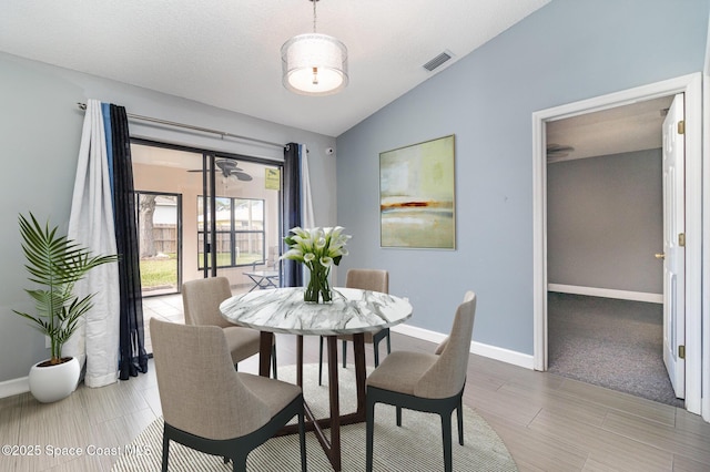 dining area featuring lofted ceiling