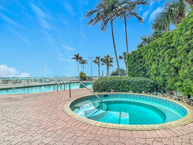 view of pool with a community hot tub