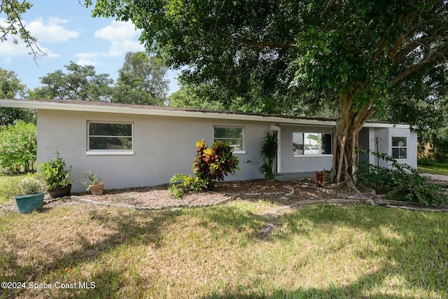 ranch-style house with a front lawn