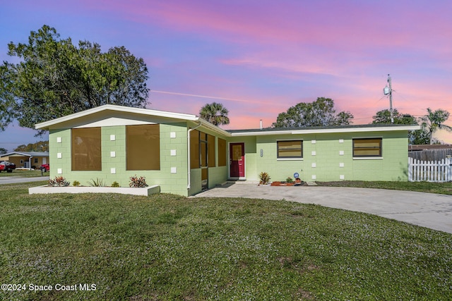 view of front of house featuring a lawn and a carport