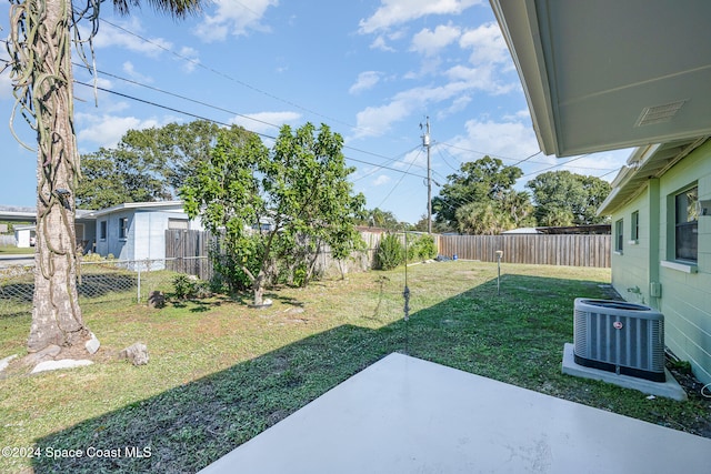 view of yard with cooling unit and a patio area