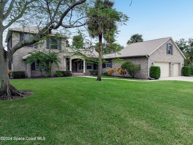 view of front facade featuring a front yard and a garage