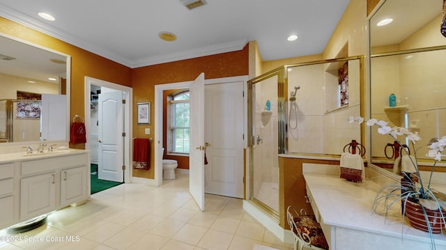 bathroom featuring tile patterned flooring, vanity, toilet, and a shower with door