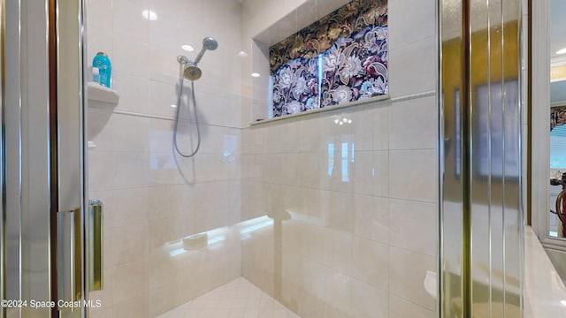 bathroom with a shower with shower door