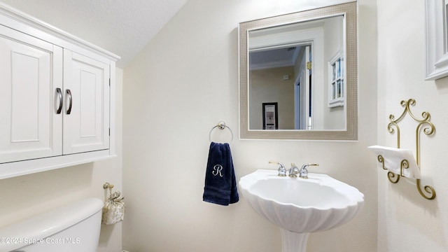 bathroom featuring sink, a textured ceiling, and toilet