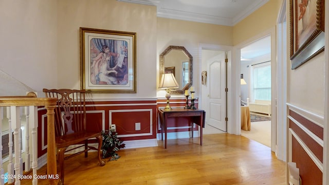 interior space with light hardwood / wood-style floors and crown molding