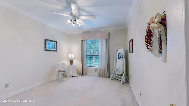 sitting room with crown molding, ceiling fan, and light carpet