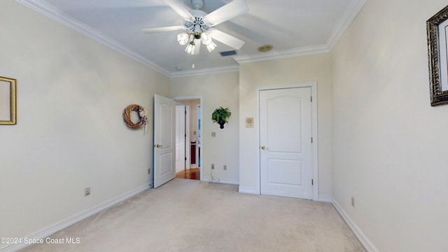 unfurnished bedroom with ceiling fan, crown molding, and light carpet