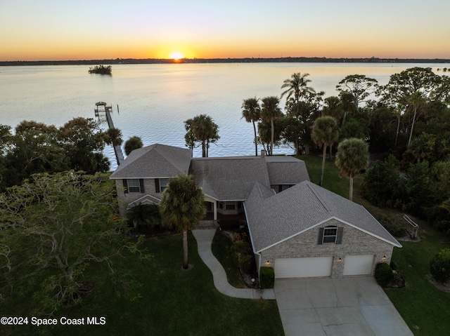 aerial view at dusk with a water view