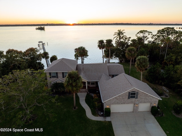 aerial view at dusk with a water view