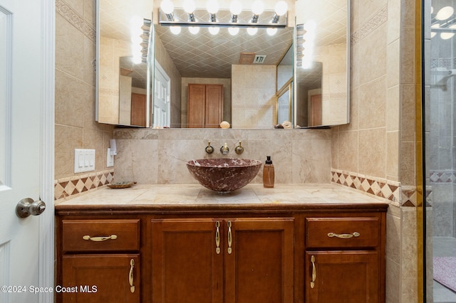 bathroom featuring tasteful backsplash, vanity, and tile walls