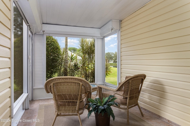 sunroom / solarium featuring wooden ceiling and a healthy amount of sunlight