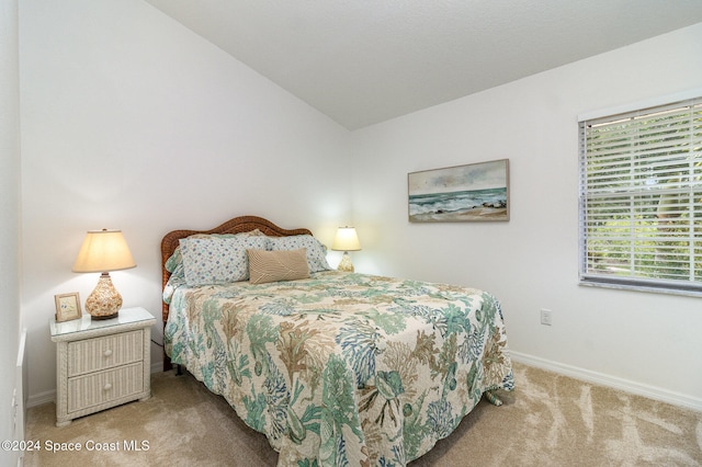 bedroom featuring carpet floors and lofted ceiling