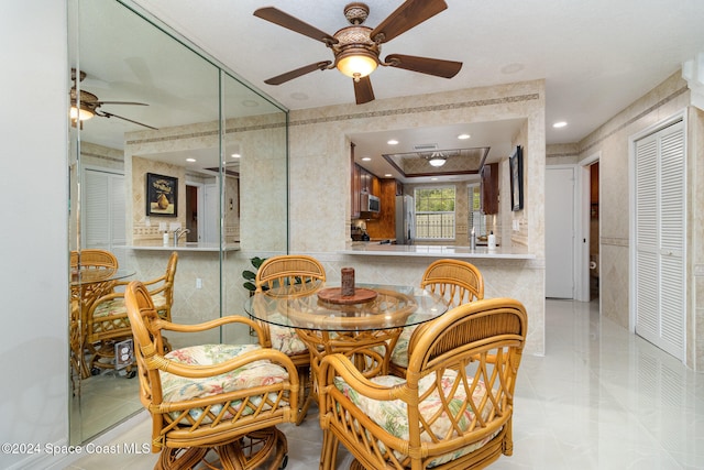 dining area with ceiling fan and light tile patterned floors