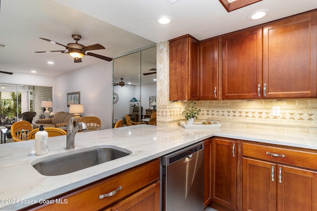 kitchen with light stone countertops, kitchen peninsula, tasteful backsplash, stainless steel dishwasher, and sink