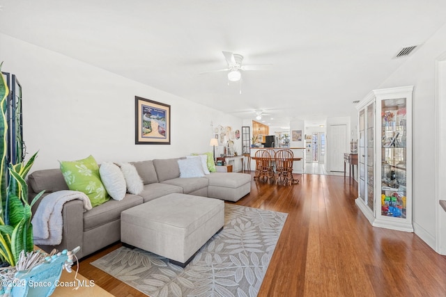 living room featuring ceiling fan and light hardwood / wood-style flooring