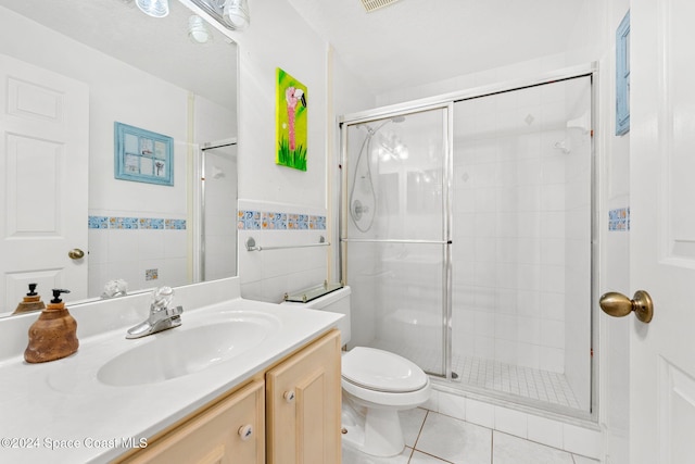 550 S Brevard Ave Unit 523, Cocoa Beach, FL 32931 - bathroom featuring vanity, toilet, a shower stall, tile patterned floors, and tile walls