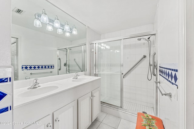 550 S Brevard Ave Unit 523, Cocoa Beach, FL 32931 - bathroom featuring a stall shower, tile patterned floors, and double vanity