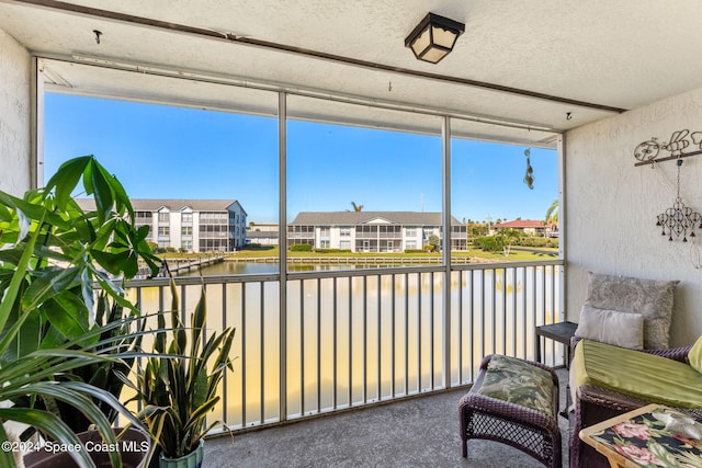 sunroom / solarium with a water view