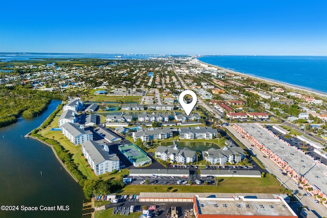 birds eye view of property with a view of the beach and a water view