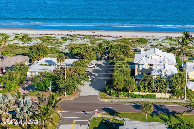 drone / aerial view featuring a beach view and a water view