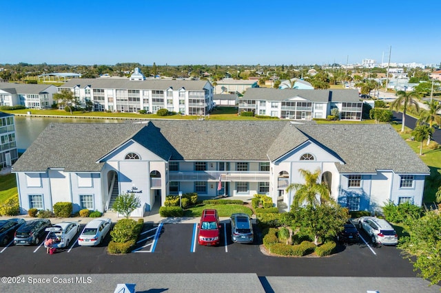 550 S Brevard Ave Unit 523, Cocoa Beach, FL 32931 - view of building exterior featuring uncovered parking and a residential view