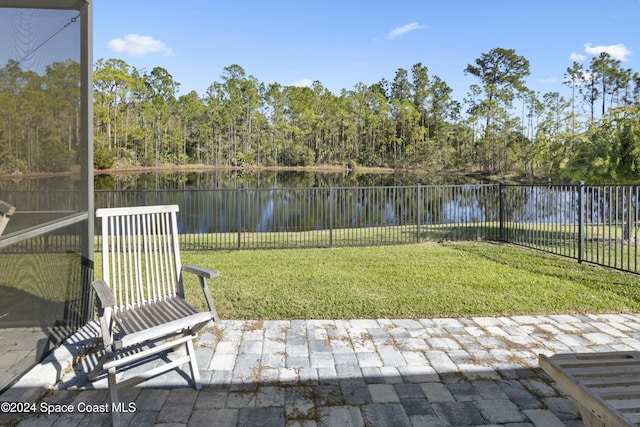 view of yard featuring a water view and a patio