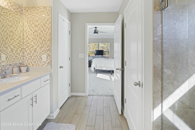 bathroom featuring hardwood / wood-style floors, ceiling fan, tile walls, and vanity