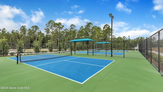 view of tennis court featuring basketball hoop