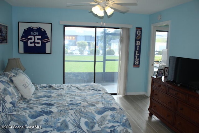 bedroom with light hardwood / wood-style floors, access to exterior, and multiple windows