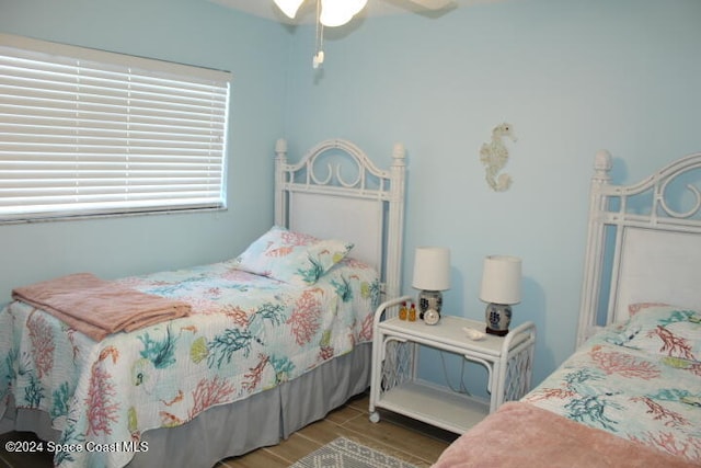 bedroom with ceiling fan and wood-type flooring