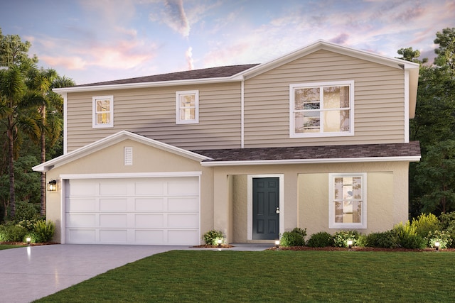 view of front of home with a garage and a yard