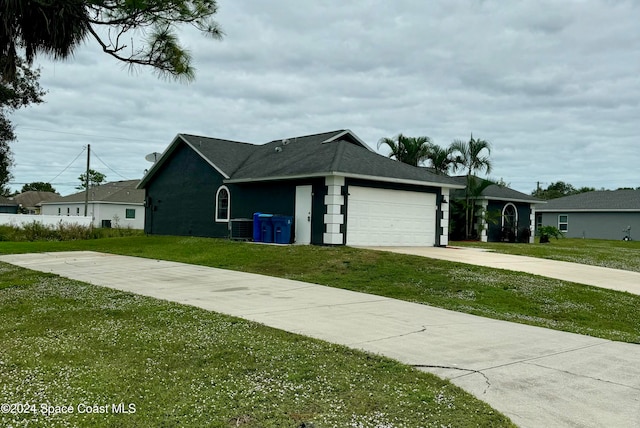 ranch-style house featuring a garage and a front lawn