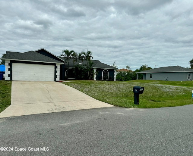 ranch-style home with a front yard and a garage