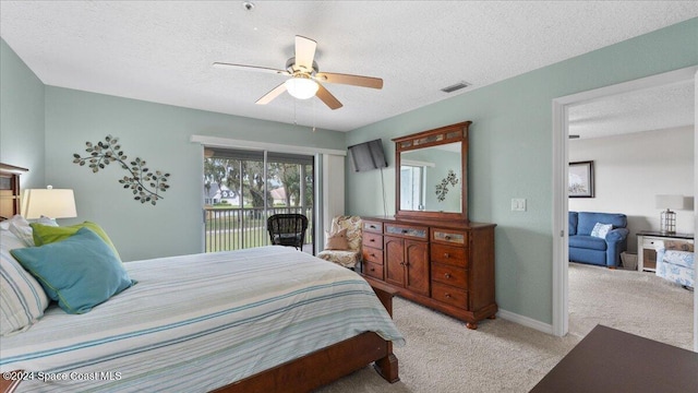 carpeted bedroom with ceiling fan, a textured ceiling, and access to outside