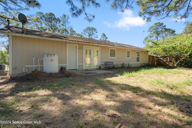 rear view of property with french doors and central AC