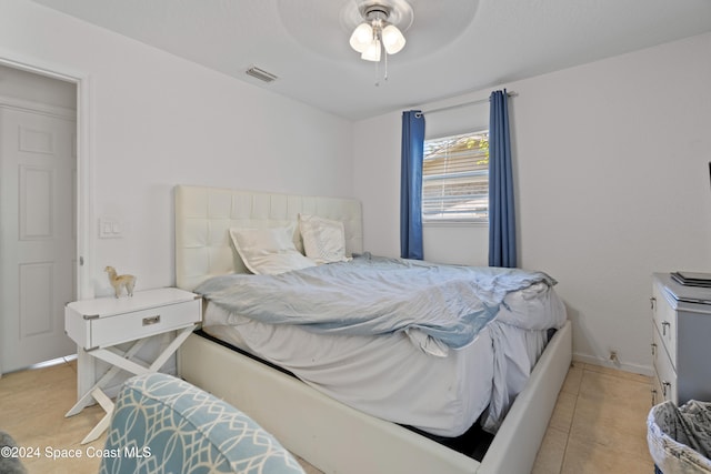 tiled bedroom featuring ceiling fan