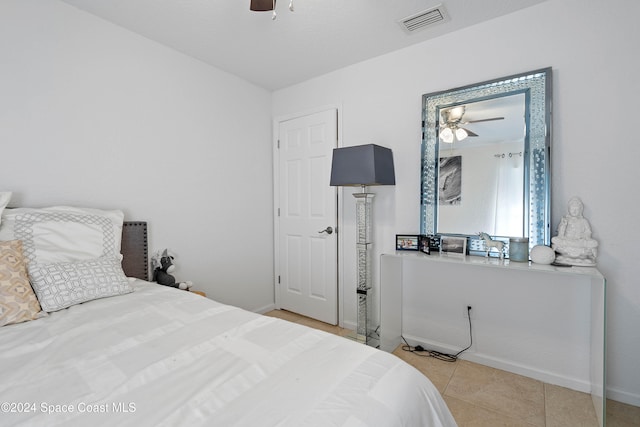 tiled bedroom with ceiling fan