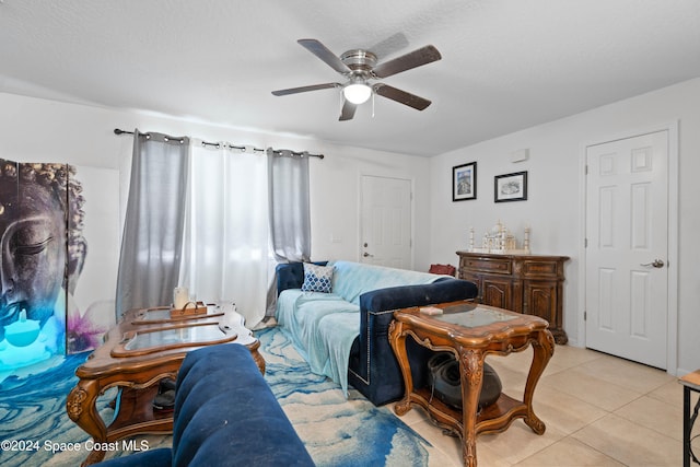 tiled living room featuring ceiling fan and a textured ceiling